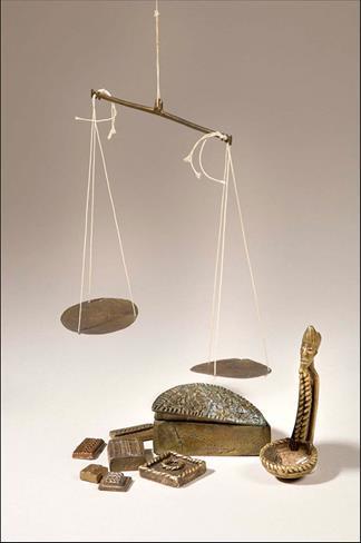 Figure 4: A scale, "Nsania", a decorative brass spoon, "famfa" and other Akan Gold-weights. Image size: 544 × 613